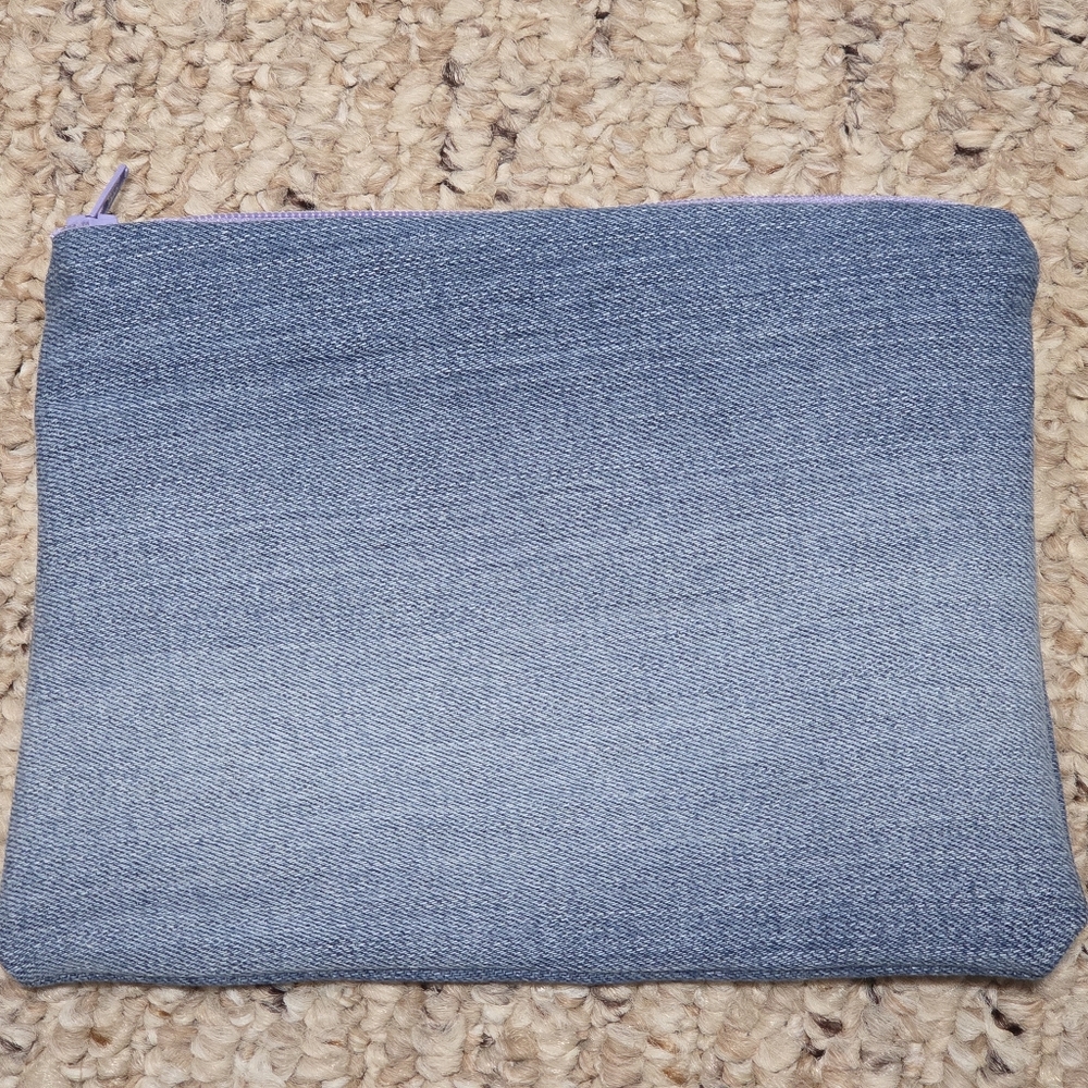 Blue Denim Pouch With A Light Purple Zipper